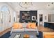 Spacious living room featuring a custom bookshelf, hardwood floors, and an elegant chandelier at 220 3Rd St, Fayetteville, GA 30214