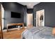A stylish main bedroom features a mounted TV, walk-in closet, and a contemporary design at 220 3Rd St, Fayetteville, GA 30214