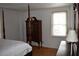 Cozy bedroom with hardwood floors, a window for natural light, and vintage furniture at 300 Peachtree Ne St # 9A, Atlanta, GA 30308