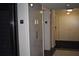 Hallway featuring elevator doors and neutral walls with an exit sign to the right at 300 Peachtree Ne St # 9A, Atlanta, GA 30308
