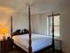 Bedroom with a four poster bed, lamps, dresser, and lots of light at 300 Peachtree Ne St # 9A, Atlanta, GA 30308