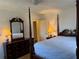 Bedroom with a four poster bed, lamps, dresser, and lots of light at 300 Peachtree Ne St # 9A, Atlanta, GA 30308