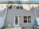 Rear view of the home, showcasing a door to the yard, multiple windows, and an AC unit at 2555 Flat Shoals Rd # 3405, Atlanta, GA 30349