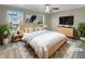 Staged bedroom with a plush rug, ceiling fan, and large windows providing plenty of natural light at 2555 Flat Shoals Rd # 3405, Atlanta, GA 30349