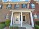 Inviting two-story brick townhouse with charming front porch and decorative black shutters at 2555 Flat Shoals Rd # 3405, Atlanta, GA 30349