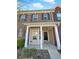 Inviting two-story brick townhouse with charming front porch and decorative black shutters at 2555 Flat Shoals Rd # 3405, Atlanta, GA 30349