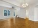 An open-concept living room featuring beautiful wood flooring and a decorative chandelier at 2555 Flat Shoals Rd # 3405, Atlanta, GA 30349