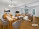 Spacious living room with hardwood floors, modern chandelier, and an abundance of natural light at 2555 Flat Shoals Rd # 3405, Atlanta, GA 30349