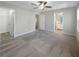 Spacious carpeted bedroom featuring a ceiling fan, closet, and ensuite bathroom at 2555 Flat Shoals Rd # 3405, Atlanta, GA 30349