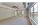 Large main bedroom featuring tray ceiling, a ceiling fan, and an en-suite bathroom at 3035 Sherbourne Dr, Lithonia, GA 30058