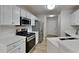 Bright kitchen features modern stainless steel appliances, including a gas range and ample counter space at 3035 Sherbourne Dr, Lithonia, GA 30058
