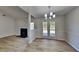 Bright living room adjacent to dining area with a fireplace, new floors, and lots of natural light at 3035 Sherbourne Dr, Lithonia, GA 30058