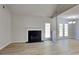 Open living room with vaulted ceiling, fireplace, and French doors leading to the backyard at 3035 Sherbourne Dr, Lithonia, GA 30058