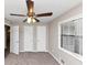 Bedroom featuring neutral walls, ceiling fan, window and closet doors at 2780 Creekwood Ln, Lawrenceville, GA 30044
