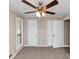 Bedroom with neutral walls, ceiling fan, a window and closet doors at 2780 Creekwood Ln, Lawrenceville, GA 30044