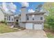 Charming home featuring a two-car garage, gray siding, and a well-maintained front yard at 2780 Creekwood Ln, Lawrenceville, GA 30044