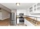 Modern kitchen features stainless steel appliances, granite counters, and white cabinets at 2780 Creekwood Ln, Lawrenceville, GA 30044