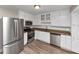 Well-equipped kitchen with stainless steel appliances, granite countertops, and white cabinetry at 2780 Creekwood Ln, Lawrenceville, GA 30044