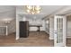 Open floorplan with view of the kitchen, complete with stainless steel appliances and white cabinets at 2780 Creekwood Ln, Lawrenceville, GA 30044