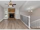 Spacious living room with hardwood floors, a stone fireplace, and large windows at 2780 Creekwood Ln, Lawrenceville, GA 30044
