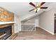 Open-concept living room featuring a fireplace, hardwood floors, and a ceiling fan at 2780 Creekwood Ln, Lawrenceville, GA 30044