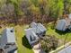 Aerial view of a two-story house surrounded by lush trees and a manicured lawn at 4542 White Rd, Douglasville, GA 30135
