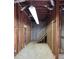 Unfinished basement featuring stud walls, concrete floors, and wooden staircase leading to upper level at 4542 White Rd, Douglasville, GA 30135