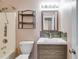 This bathroom features a shower-tub combo with brushed chrome fixtures, storage shelving, and a floating vanity with a white countertop at 4542 White Rd, Douglasville, GA 30135