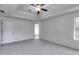This bedroom features fresh paint, plush carpet, a ceiling fan, and lots of natural light at 4542 White Rd, Douglasville, GA 30135