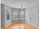 Bright dining area with hardwood floors, three large windows, and a chandelier at 4542 White Rd, Douglasville, GA 30135