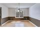 Bright dining room featuring hardwood floors and stylish wainscoting, perfect for Gathering meals at 4542 White Rd, Douglasville, GA 30135