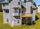Back exterior elevation view of home with a deck, multiple windows, and access to the backyard at 4542 White Rd, Douglasville, GA 30135
