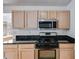 Well-lit kitchen features granite countertops and stainless steel appliances at 4542 White Rd, Douglasville, GA 30135