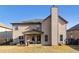 Backyard of home with patio, grill, and full privacy fence under a blue sky at 817 Nevis Way, Mcdonough, GA 30253