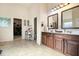 Bright bathroom with double vanity, tile flooring and access to closet at 817 Nevis Way, Mcdonough, GA 30253