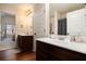 Well-lit bathroom with double sink vanity, framed mirrors, and wood-look floors at 817 Nevis Way, Mcdonough, GA 30253