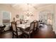 Elegant dining room features a large wooden table and chairs, coffered ceilings and hardwood flooring at 817 Nevis Way, Mcdonough, GA 30253