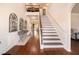 Grand foyer with hardwood floors, staircase and elegant decor, leading to various living spaces at 817 Nevis Way, Mcdonough, GA 30253