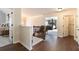 Hallway with wooden floors leading to bedroom with four-poster bed and laundry room at 817 Nevis Way, Mcdonough, GA 30253