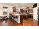Spacious kitchen featuring dark cabinetry, granite countertops, stainless steel appliances, and a breakfast bar at 817 Nevis Way, Mcdonough, GA 30253