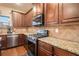 Well-equipped kitchen features granite countertops, stainless steel appliances, and dark wood cabinetry at 817 Nevis Way, Mcdonough, GA 30253