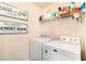 Functional laundry room with washer, dryer, and storage for cleaning supplies at 817 Nevis Way, Mcdonough, GA 30253