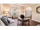 Cozy living room with large windows, decorative pillows, and an ornate coffee table for gatherings at 817 Nevis Way, Mcdonough, GA 30253