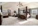 Spacious main bedroom with four-poster bed, multiple windows and carpeted floor at 817 Nevis Way, Mcdonough, GA 30253