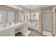 Bright bathroom with a double sink vanity, separate tub and shower with gold trim at 2983 Bancroft Nw Gln, Kennesaw, GA 30144