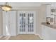 Light-filled dining area featuring glass French doors and ample cabinet space at 2983 Bancroft Nw Gln, Kennesaw, GA 30144
