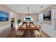 Formal dining room with hardwood floors, modern lighting fixture, and adjacent kitchen view at 2983 Bancroft Nw Gln, Kennesaw, GA 30144