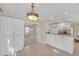 Open-concept dining and kitchenette area with white cabinetry and decorative chandelier at 2983 Bancroft Nw Gln, Kennesaw, GA 30144