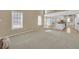 Spacious living room with large windows and an open view of the adjoining kitchen at 2983 Bancroft Nw Gln, Kennesaw, GA 30144