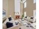 Bright living room featuring a fireplace, soaring ceilings, and modern furniture at 2983 Bancroft Nw Gln, Kennesaw, GA 30144